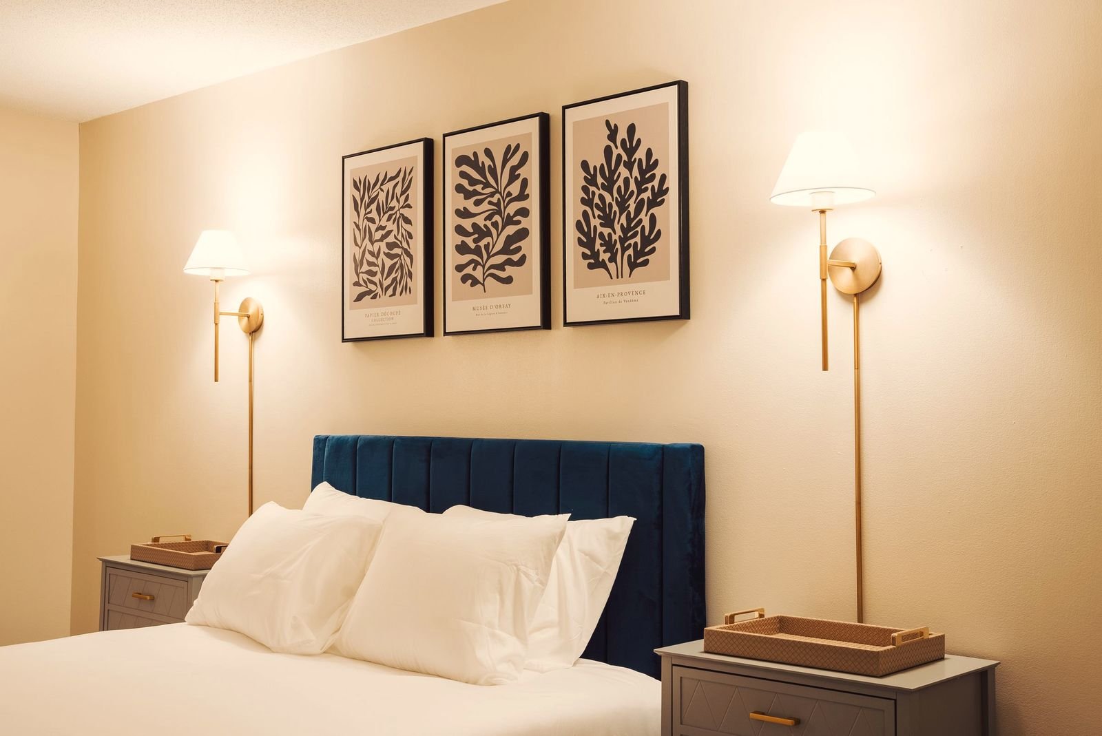 King room with the bedside lamps on and a desk by the window